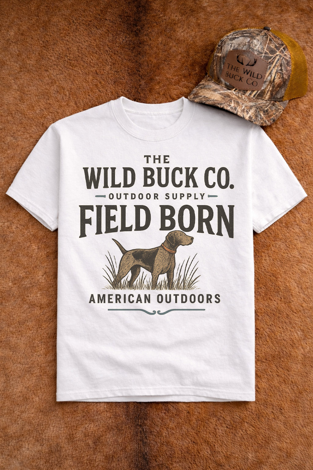 White t-shirt with 'The Wild Buck Co.' text and graphic on a brown leather background