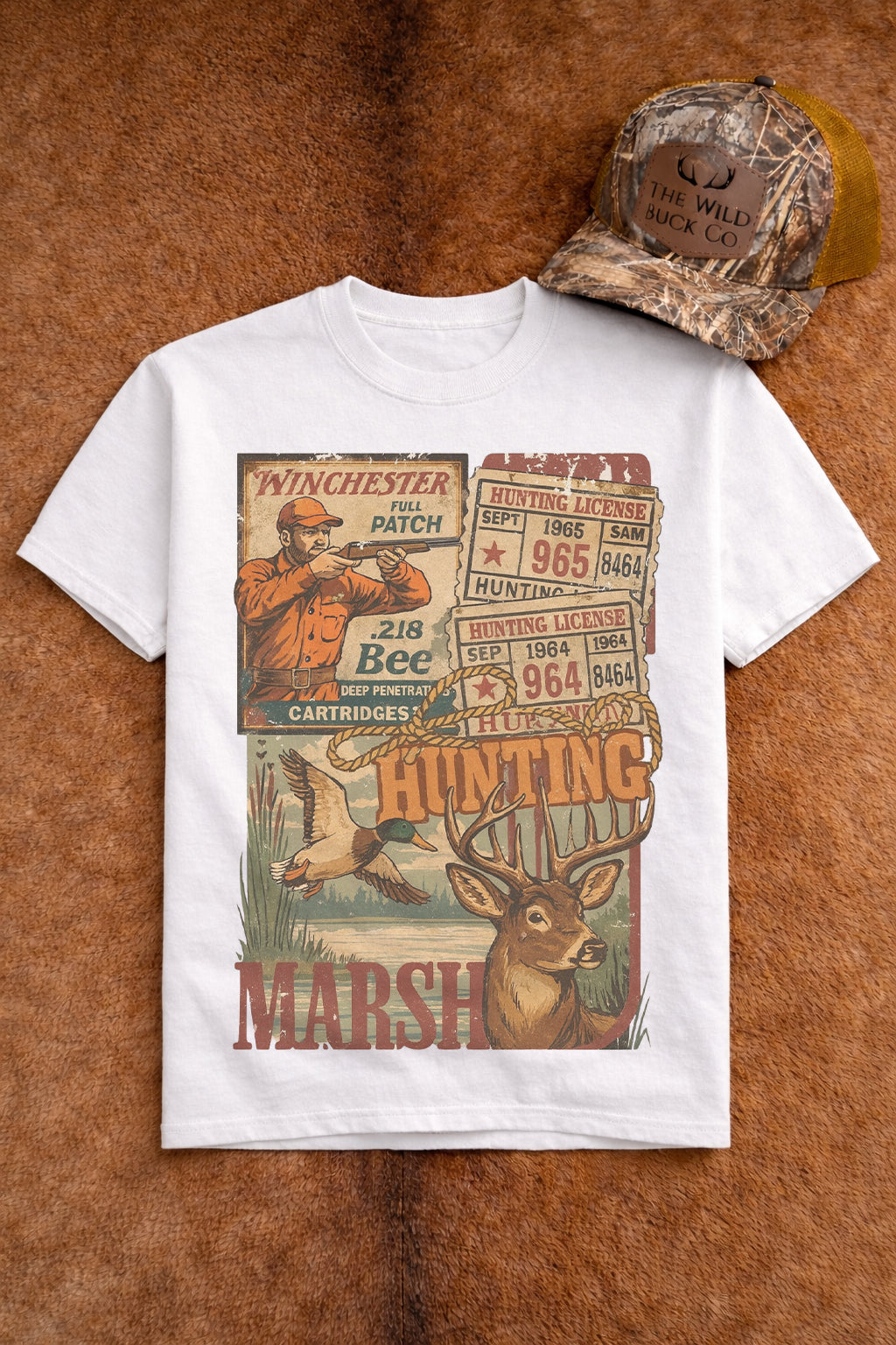 White t-shirt with hunting-themed graphic design on a brown leather background